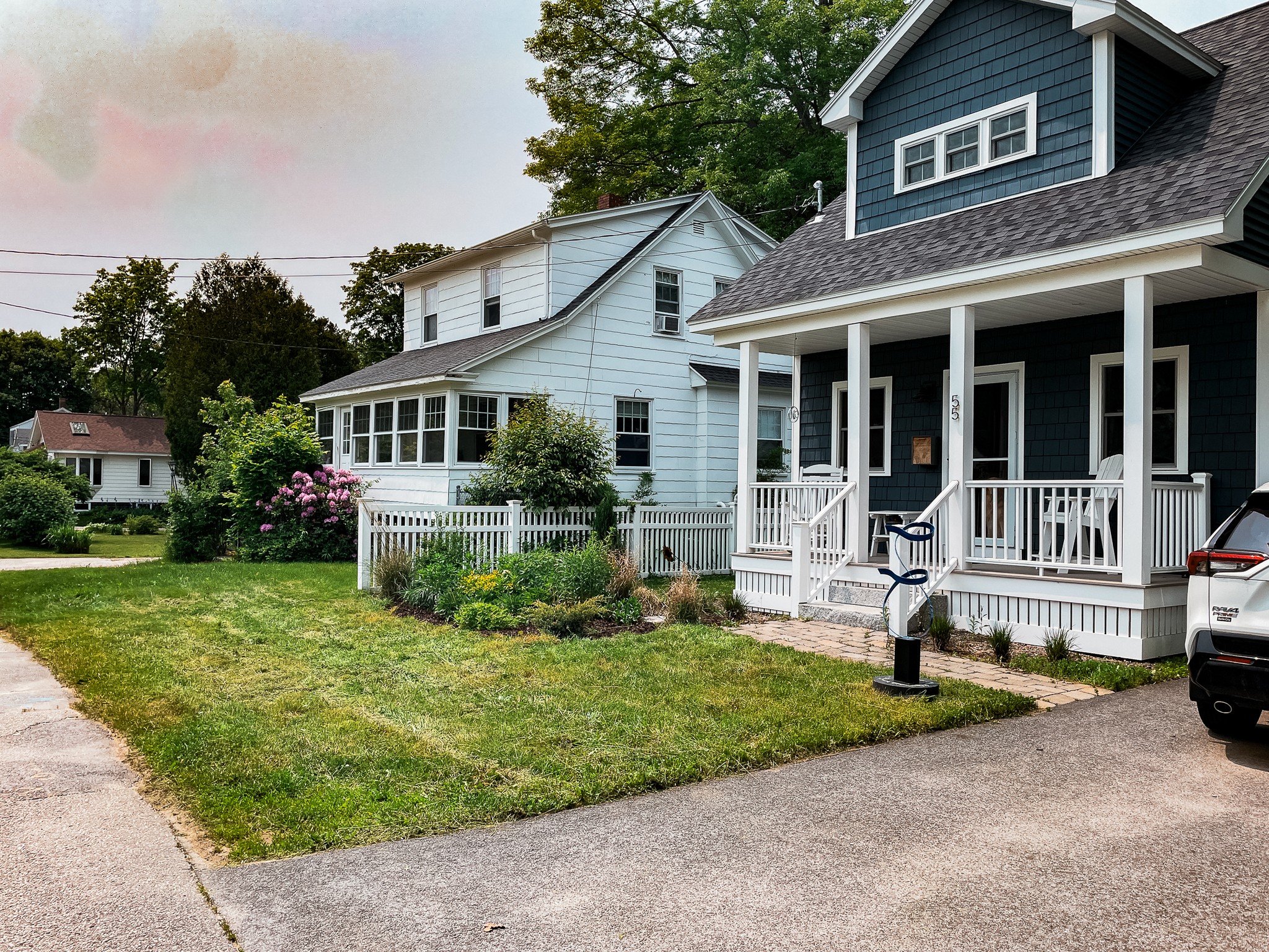 Front of home with colorful garden beds and plantings